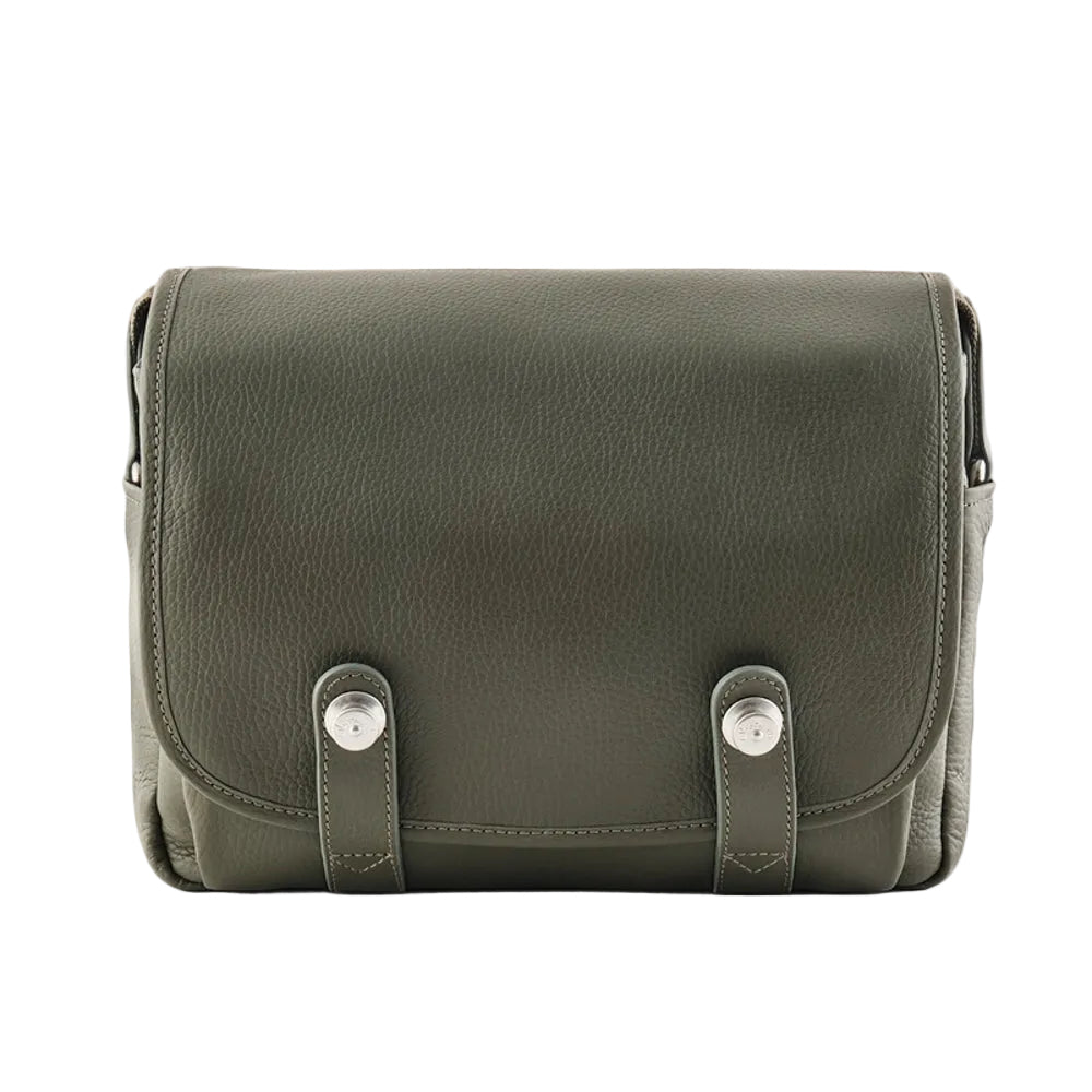 Green leather bag with silver buckles on a white background